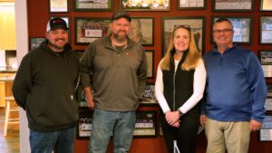 Lighting up two-gigabit fiber – from left: Smithville technicians (and Bedford residents) Ryan Blann and Travis Enochs pause with Paige and Jeff Callahan after activating Smithville’s first multi-gig residential fiber service at the Callahan home. 